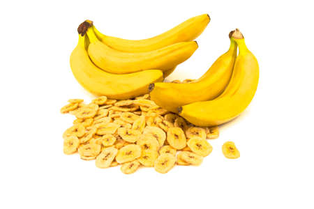 Macro view of dried banana chips with banana branch isolated on white backgroundの写真素材