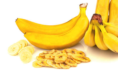 Macro view of heap of dried banana chips with banana bunch on white backgroundの写真素材