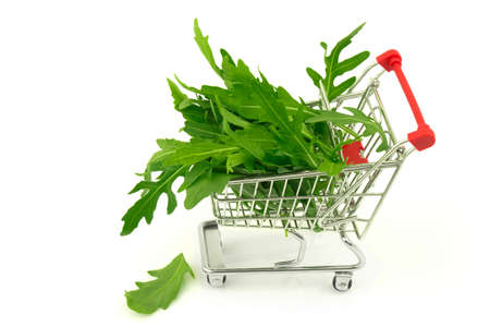 Bunch of arugula in metal trolley isolated on white backgroundの写真素材