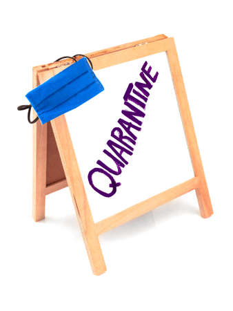 Coronavirus concept with text quarantine, announcement on wooden board, blackboard, chalkboard, frame and blue protective medicine surgical equipment mask. Isolated on white background.の写真素材