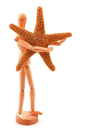 Concept with sea star, seastar and standing wooden toy. Isolated on white background.の写真素材