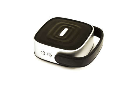 Black small portable speaker with gray, silver insert parts, holder, handle and buttons isolated on white backgroundの写真素材