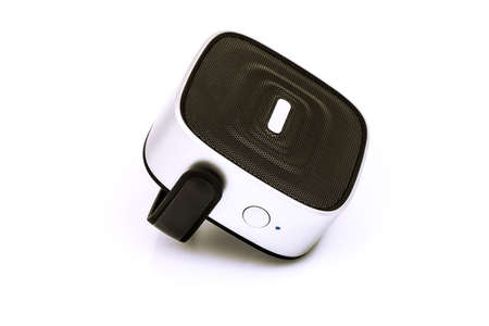 Black small portable speaker with gray, silver insert parts, holder, handle and buttons isolated on white backgroundの写真素材
