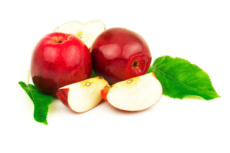 Macro view of red tasty apples with slices and green leaves. Isolated on white backgroundの写真素材