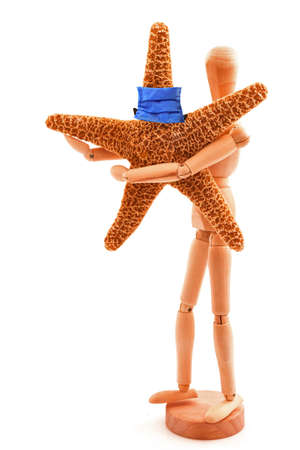 Coronavirus concept with wooden toy, sea star and blue protective medicine surgical equipment mask. Isolated on white background.の写真素材