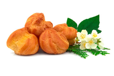 Tasty eclair, custard, cake, profiterole with fresh jasmin flower. Isolated on white background.の写真素材