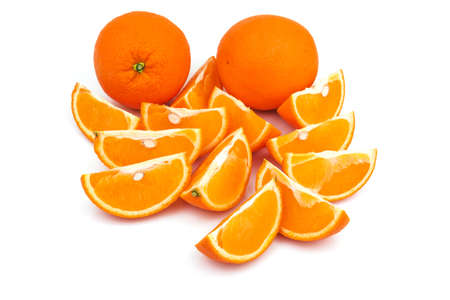 Two whole oranges with slices isolated on white backgroundの写真素材