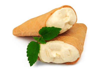 Two tasty milky ice cream in crisp waffle with green leaves of mint isolated on white backgroundの写真素材