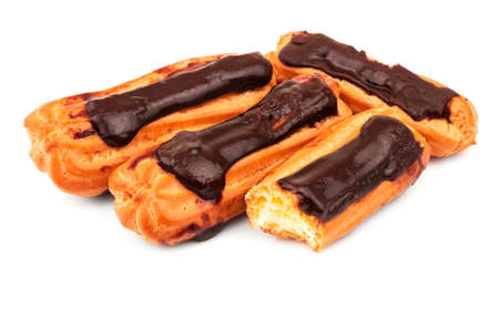 Group of French dessert eclairs with custard and chocolate icing isolated on white background. Sweet pastry products.の写真素材