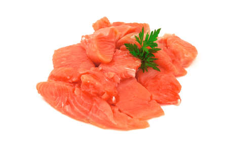 Pieces of red salmon fish with fresh parsley herbs isolated on white backgroundの写真素材