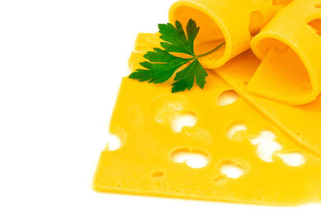 Macro view of rolled thin slices of hard yellow cheese with holes and fresh parsley on white backgroundの写真素材