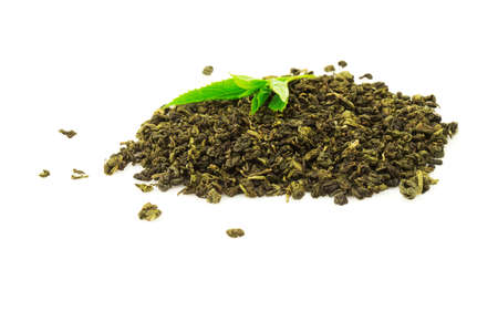 Heap of tea with fresh green leaf plant isolated on white backgroundの写真素材