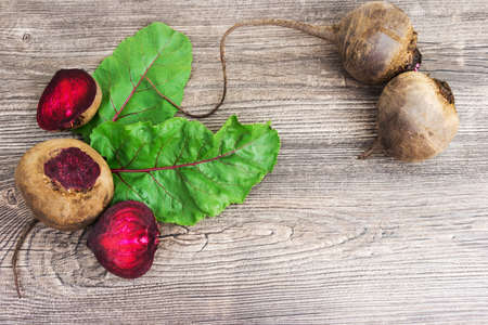 Top view at fresh organic beets with leaves on wooden rustic table background. Close up view.の写真素材
