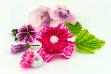 Barrette with ribbon and elastic, natural flowers and green leaf isolated on white background.の写真素材