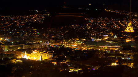 Aerial view of the night city of Tbilisi, Georgia. Panorama of urban landscapes with illumination at...