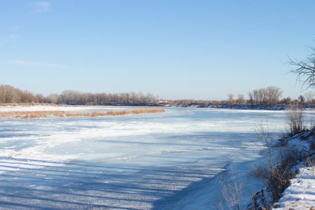Wonderful winter landscape. A frozen river against a blue sky. A place for hiking and traveling. Stunning nature background. winter backgroundの写真素材