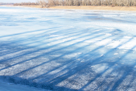 Wonderful winter landscape. A frozen river against a blue sky. A place for hiking and traveling. Stunning nature background. winter backgroundの写真素材