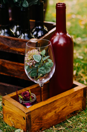 Beautiful decor with wine bottles, wooden boxes and other elements in nature.の写真素材