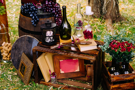Beautiful decor with wine bottles, wooden boxes and other elements in nature.の写真素材