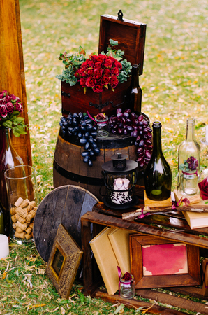Beautiful decor with wine bottles, wooden boxes and other elements in nature.の写真素材