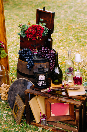 Beautiful decor with wine bottles, wooden boxes and other elements in nature.の写真素材