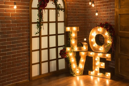 Love Light Sign Love. Brick wall with large windows and the love letters of the lamps.の写真素材