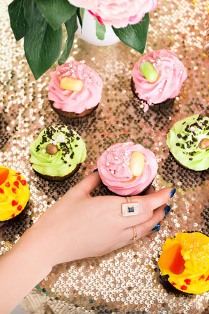 Bright colored cupcakes. yellow, green and pink cakes