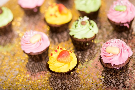 Bright colored cupcakes. yellow, green and pink cakesの写真素材