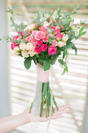 Wedding bouquet of roses in the hands of the bride. wedding flowers.の写真素材