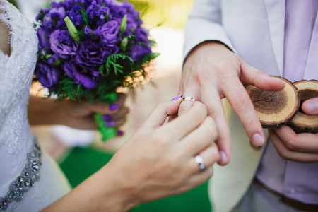 wearing wedding ring ceremony tradition. wedding concept. The bride and groom exchange rings.の写真素材