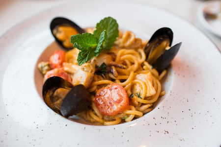 Spaghetti with mussels seafood. Soba noodles with shrimps and vegetables. Asian food. Pasta with seafood in tomato sauce. Top view.の写真素材