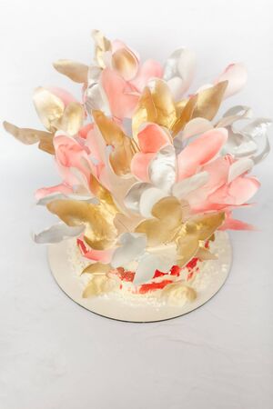 A wedding cake. Sweets for Valentine's Day. Festive white cake with butterfliesの写真素材