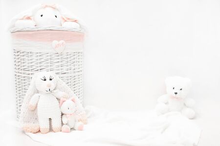White linen basket.  Children wicker laundry basket with stuffed toys.の写真素材