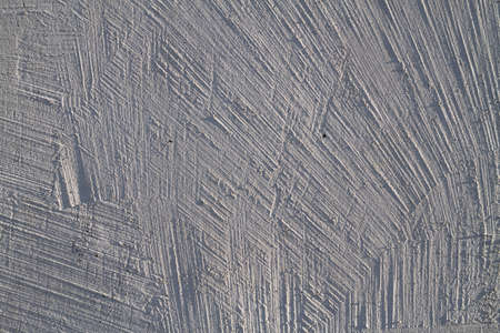 Whitewash texture on the wall with decorative brush stripes, decorative plaster of a white wall.の写真素材