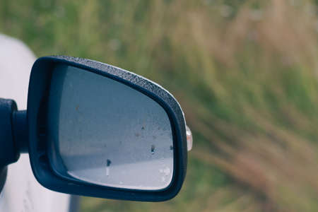 Fog condensation on the side mirror of the car early in the morning.の写真素材