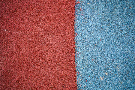 Rubber crumb for covering sports grounds and playgrounds in red and blue colorsの写真素材