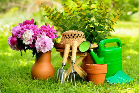 Gardening tools on green background and grassの写真素材