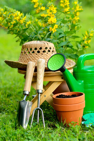Gardening tools on green background and grassの写真素材