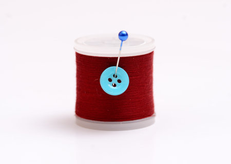 Isolated thread spool with pin on white 