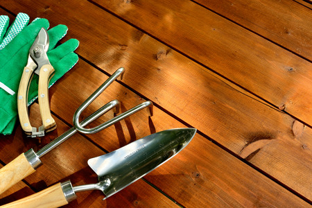 Close-up gardening tools and objects on old wooden background with copyspaceの写真素材