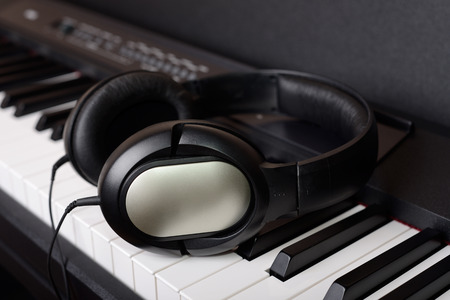 Close-up headphones on piano keyboardの写真素材