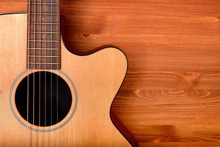 Close-up western guitar on wooden backgroundの写真素材