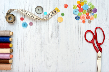 Copyspace frame with sewing tools and accesories on white wooden backgroundの写真素材