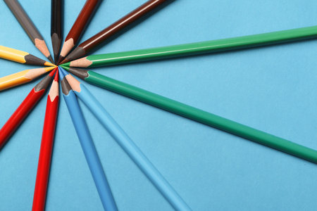 Multicolored pencils on blue background