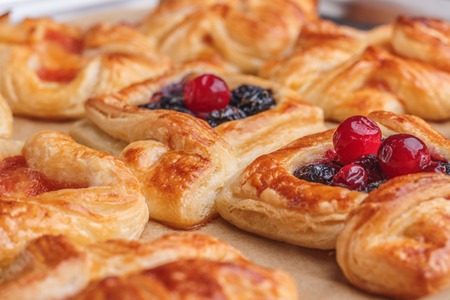 Puffs on baking paper with different fillings and shapesの写真素材