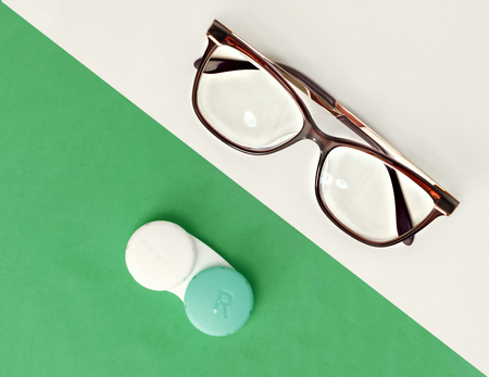 Glasses and contact lenses are white and green background. The concept of vision and choiceの写真素材