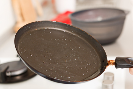 Closeup cooking on gas stove, empty frying pan with hot vegetable oilの写真素材