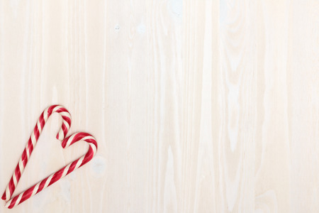 Valentine's Day. The composition of the heart of the Christmas candy on a light wooden background with texture. Top viewの写真素材