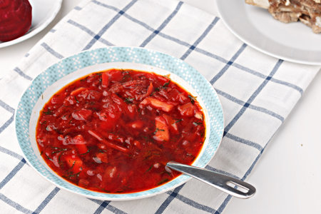 Russian and ukrainian national food - red beet soup, borscht . Closeup