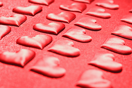 Many red hearts on a red background. Romantic love, Valentine's Day, birthday, wedding, holiday. Selective focus.の写真素材